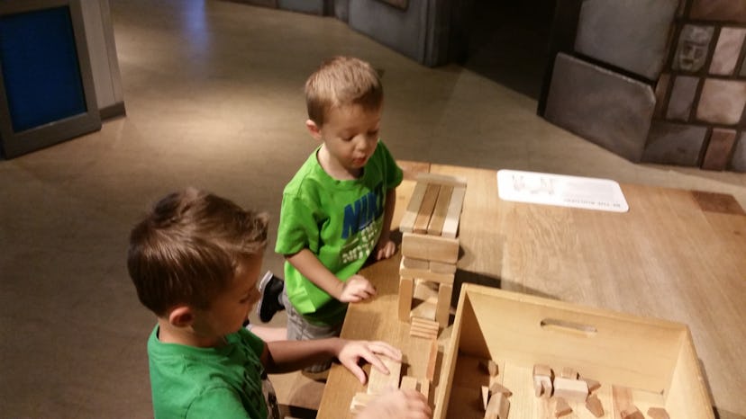 Two brothers playing with wooden blocks
