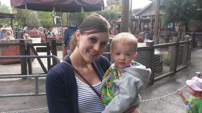 Christi Cazin smiling while holding her son