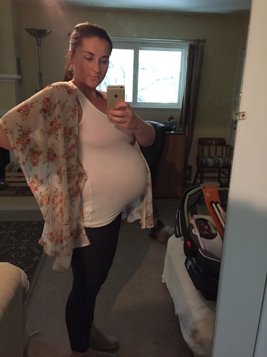 Pregnant woman taking a selfie in her apartment