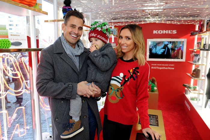 A man and woman with their child who was born via surrogacy, in Christmas outfits