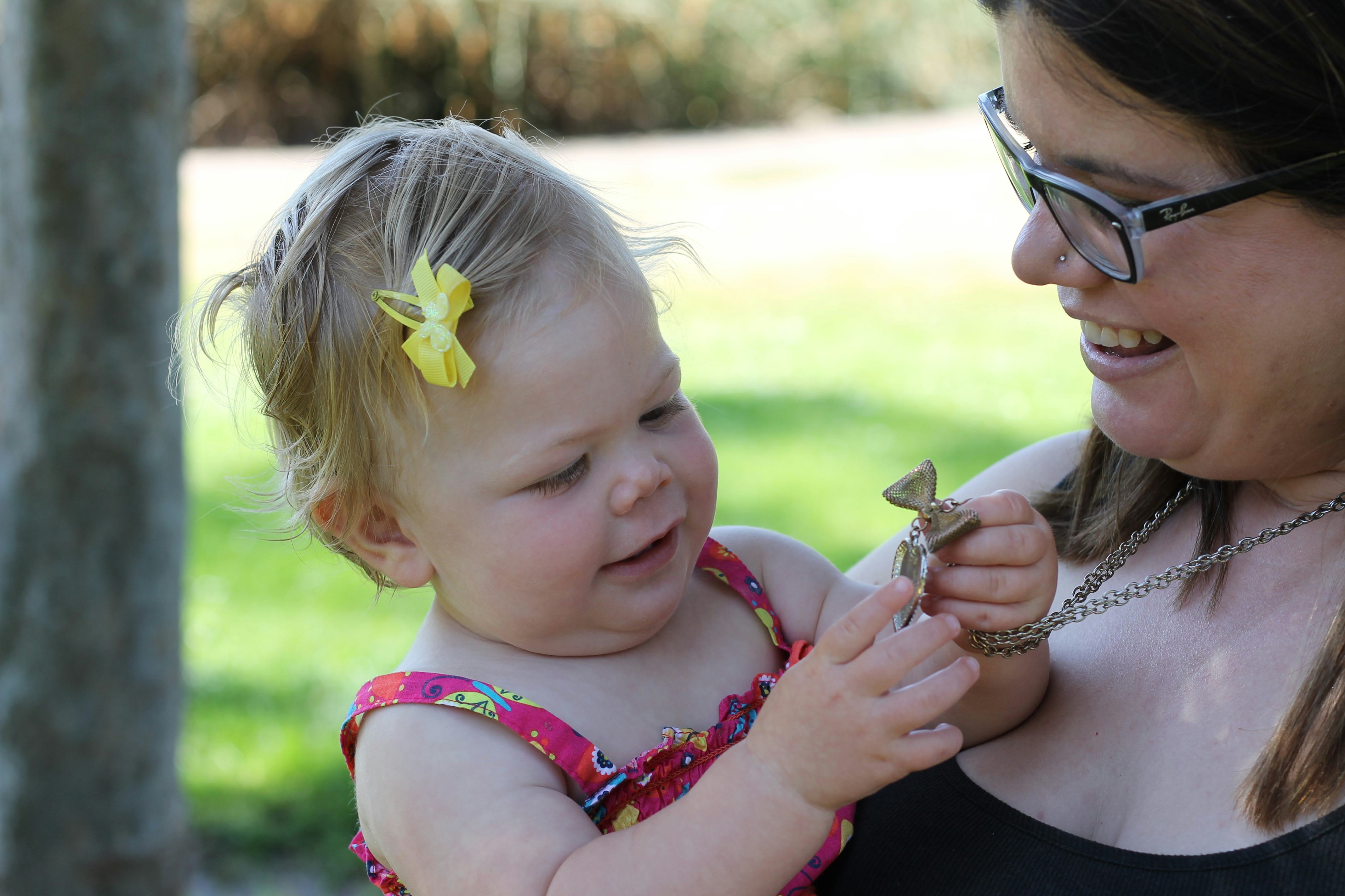 A mom holding her daughter in her arms 