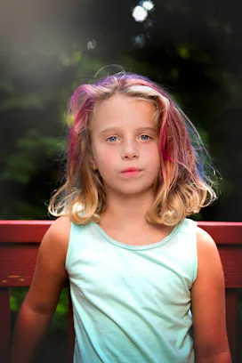 A portrait of a girl in a mint top who has had Leukemia
