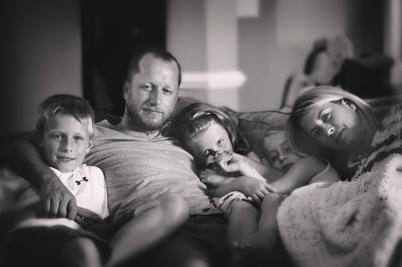The family of the girl who had leukemia all sitting in a couch together