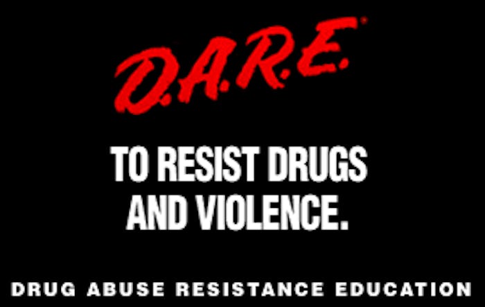 A poster for D.A.R.E. with their slogan "to resist drugs and violence" in white and "D.A.R.E." in re...