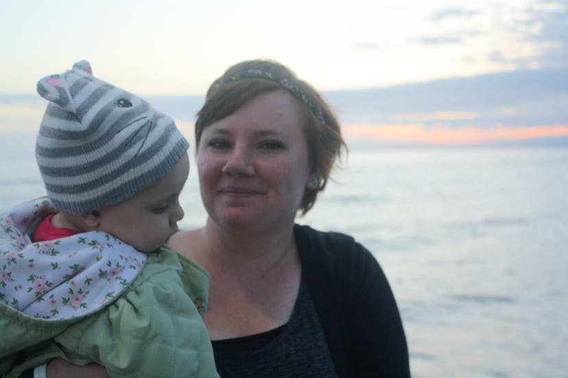 mom holding baby at the beach