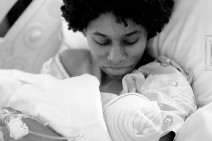 Mom holds her newborn baby after giving birth by c-section