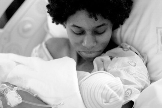 Mom holds her newborn baby after giving birth by c-section