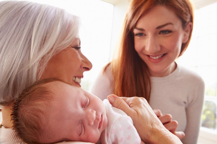 A grandmom sitting with her daughter and grandchild