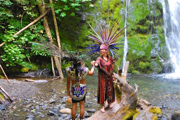 A photo taken by a nomadic mom of two spiritual dancers posing by Madison Falls