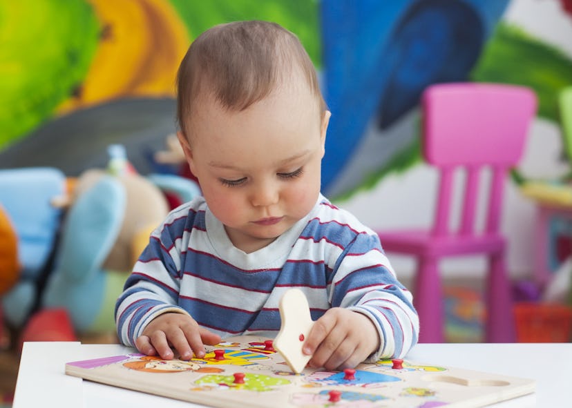 A toddler playing with puzzles