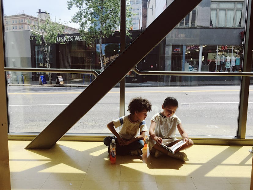 Margaret Jacobsen's kids sitting on the floor and reading