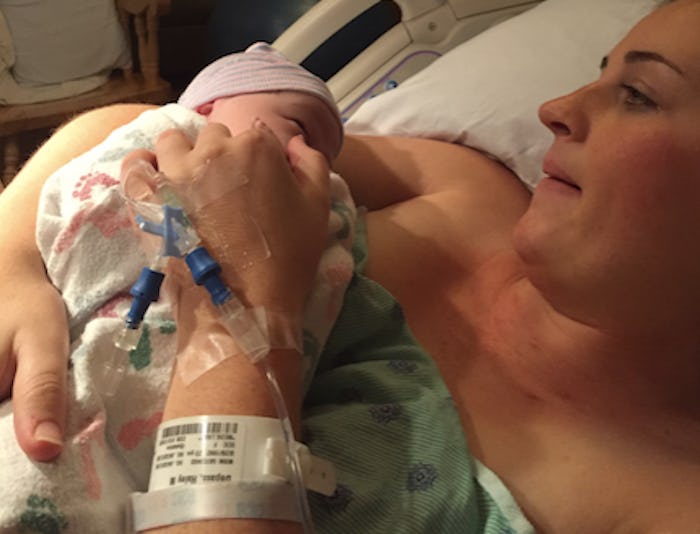 A woman holding her newborn after an induced birth