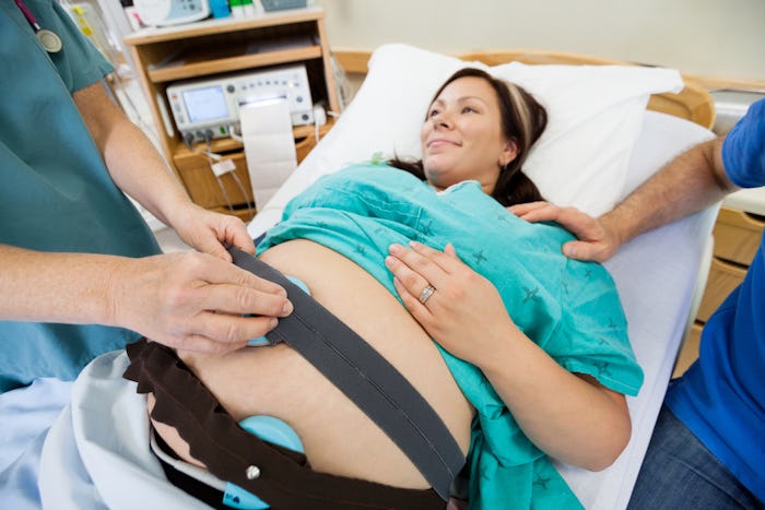 A pregnant woman being induced while lying in a hospital bed