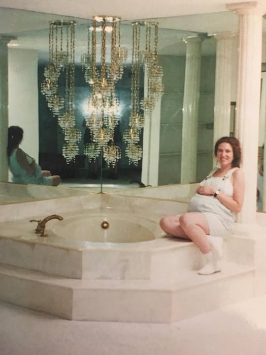 A pregnant lady sitting on the luxury in-house jacuzzi