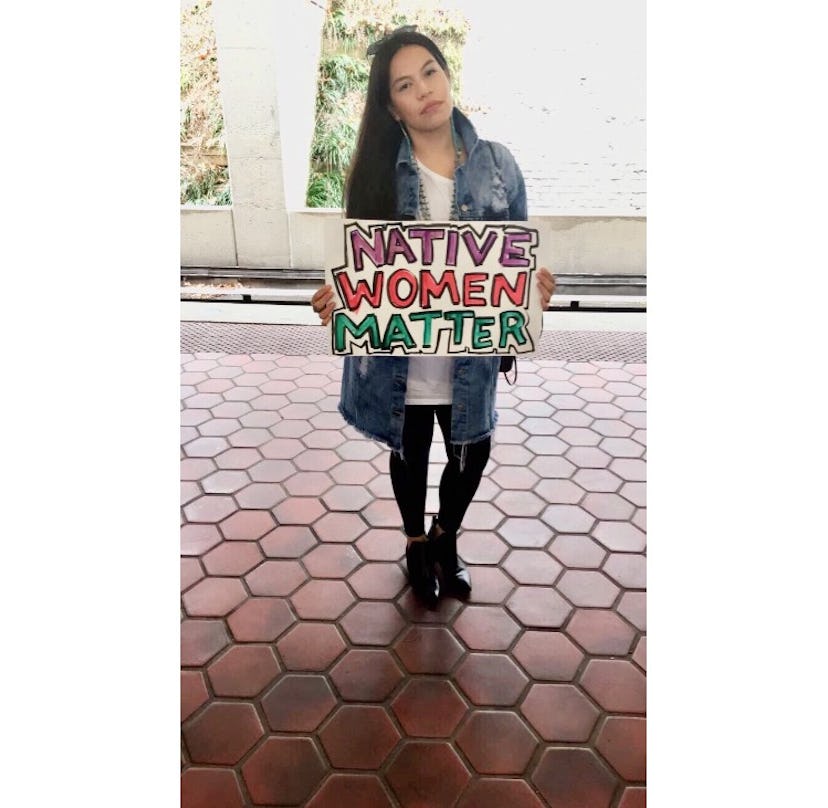 Shandean Bell holding a sign reading: 'Native Women Matter.'