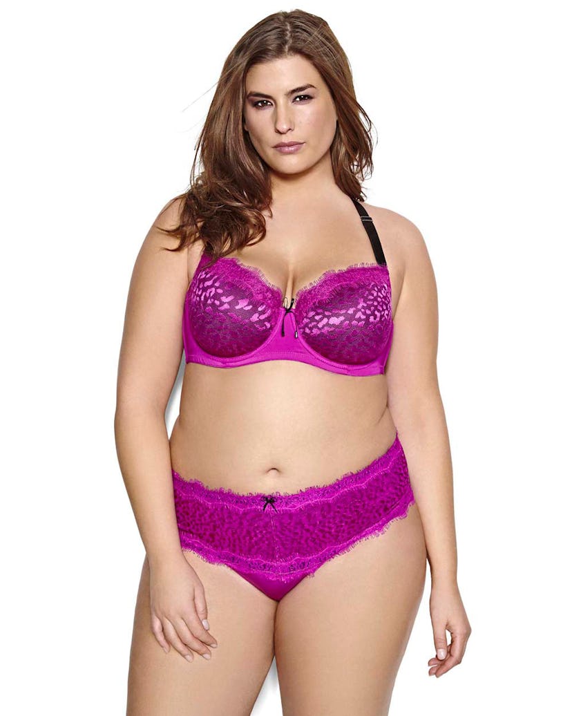 A plus size model posing in a purple leopard print showstopper bra and in a matching leopard print t...