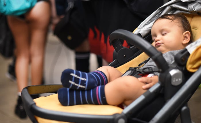 A baby sleeping in a stroller