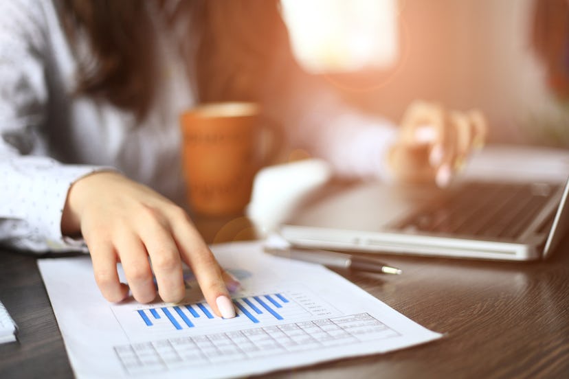 A woman working and looking at the chart