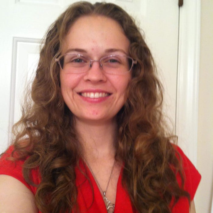 Ruby Dixon in a red shirt with glasses