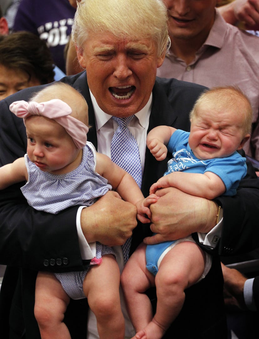 Donald Trump holding two babies