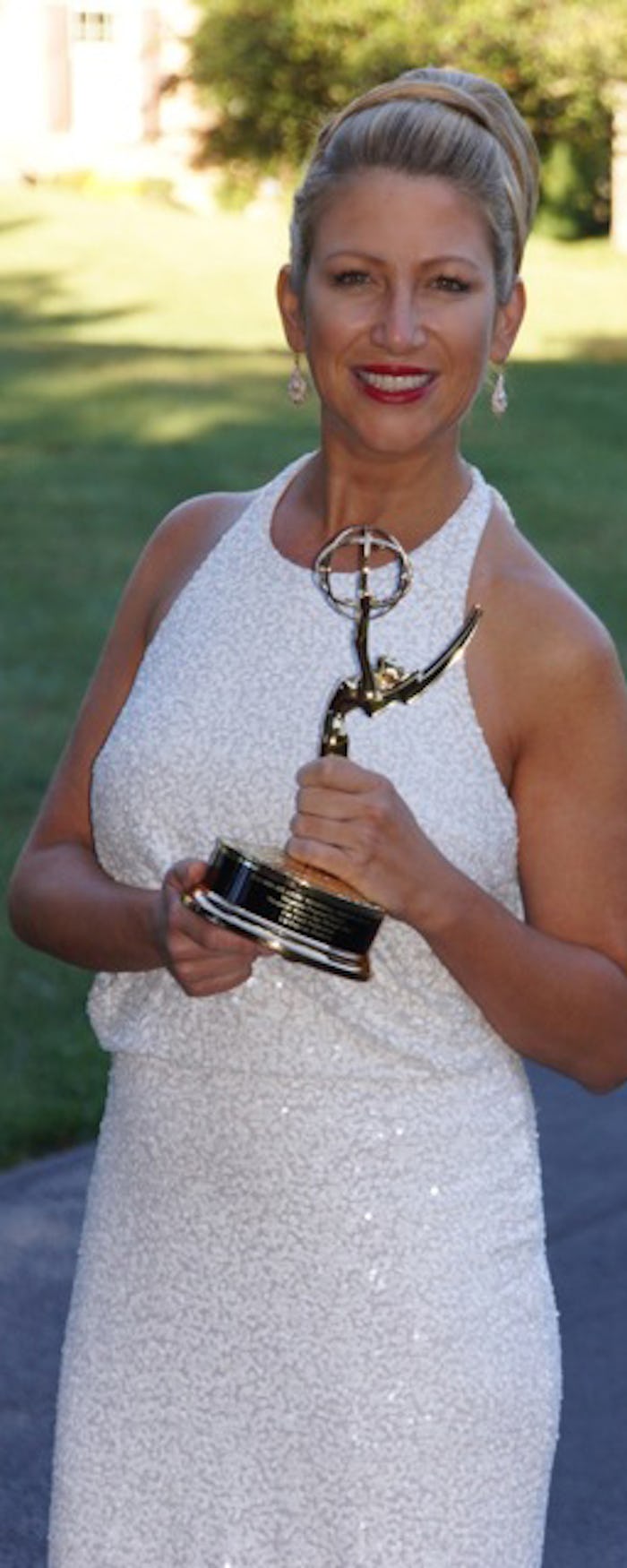 A mom posing in a white dress