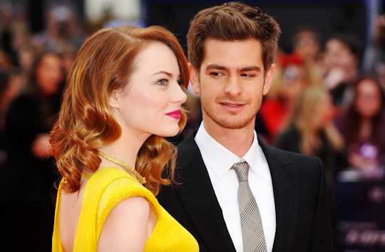 Emma Stone in a yellow dress and Andrew Garfield in a suit an tie at a red carpet