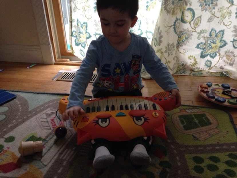A boy playing piano toy