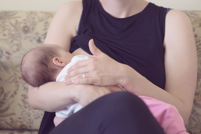 A mother holding her baby while sitting