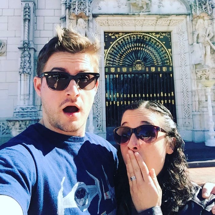 A couple standing outside on a sunny day wearing sunglasses and with looks of surprise on their face...
