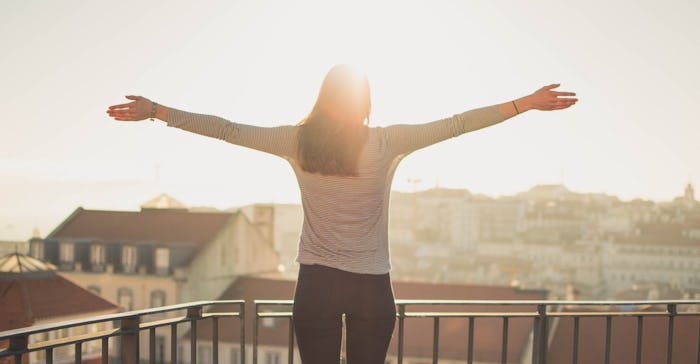 silhouette of a woman with arms raised