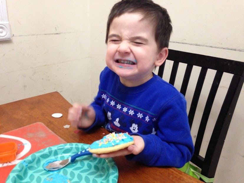 A preschooler eating a cake