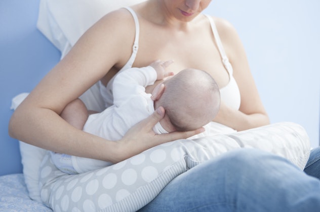 A mother holding her baby while breastfeeding