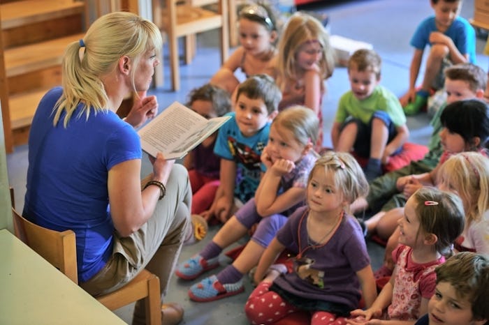 Daycare teacher talking to kids