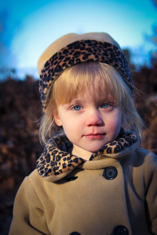 Blue-eyed little girl modeling and posing for a picture