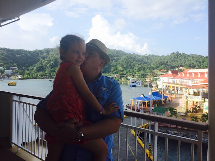 A father holding his young daddy-daughter at a balcony