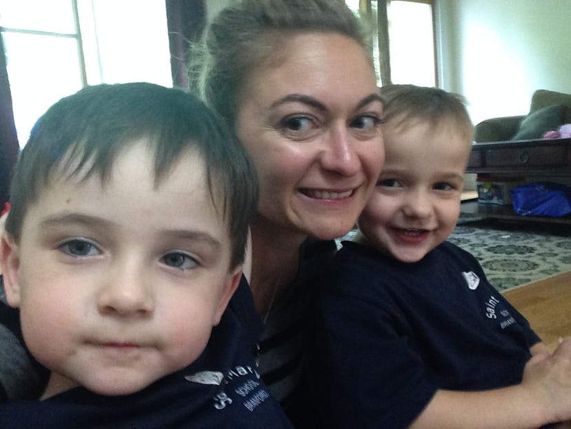 Megan Zander smiling and taking a selfie with her two sons