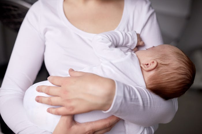 A mother holding her newborn baby