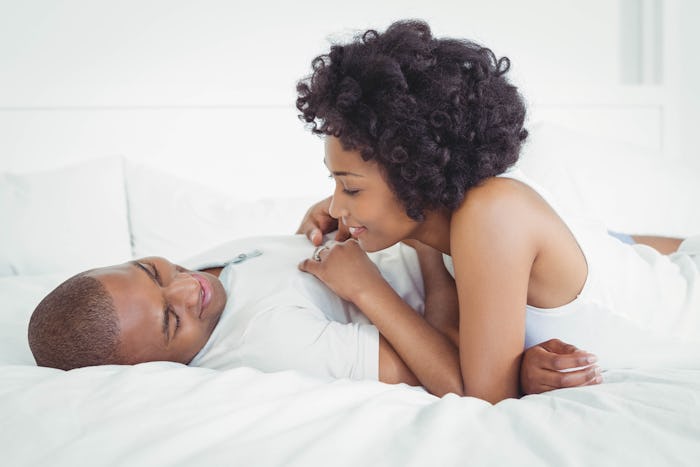 Woman feeling horny during ovulation is seducing her partner on the bed