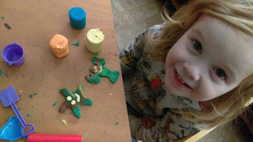 A little girl making toy shapes with clay