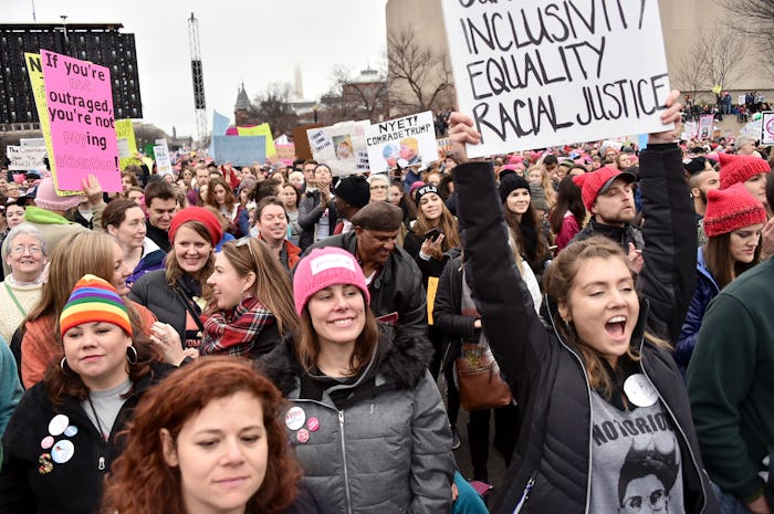 A large group of people marching with posters during the Women's strike