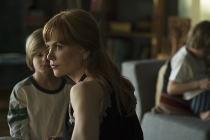 A movie scene where the actress is sitting with her child on the sofa