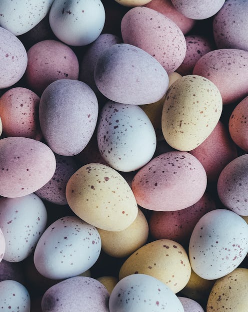 Blue, yellow, and pink Easter eggs stacked on top of each other