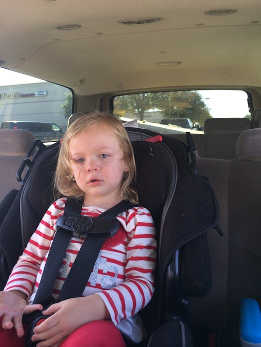 Crystal Henry's daughter sitting in a car seat and crying