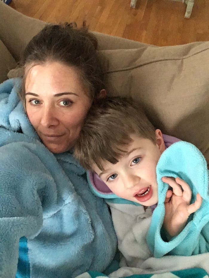 Samantha Shanley  and her sun both wearing bath robes and posing for a selfie while sitting on the c...