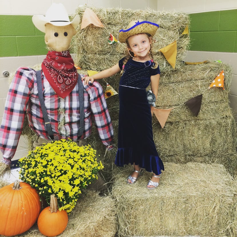 Crystal Henry's daughter posing in a cowgirl costume