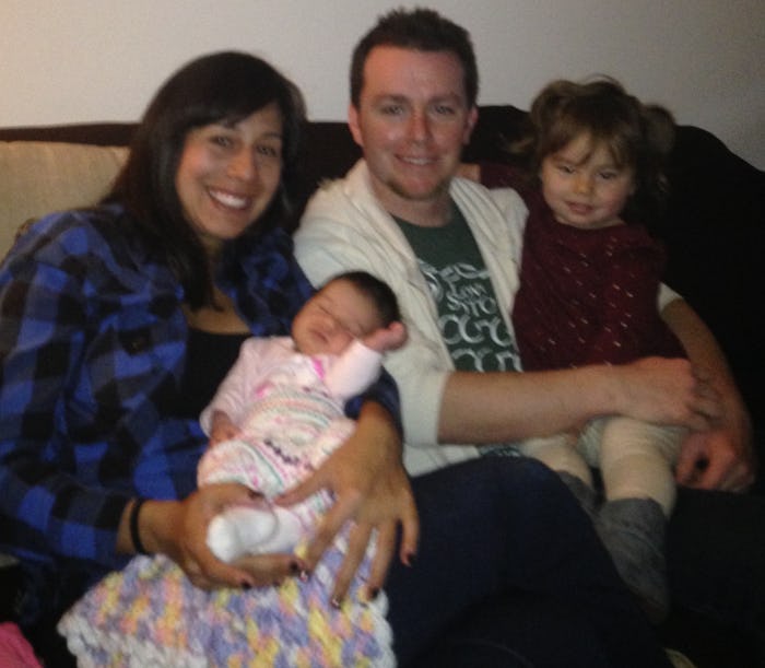 Ambrosia Brody with her husband and their two kids on a couch 