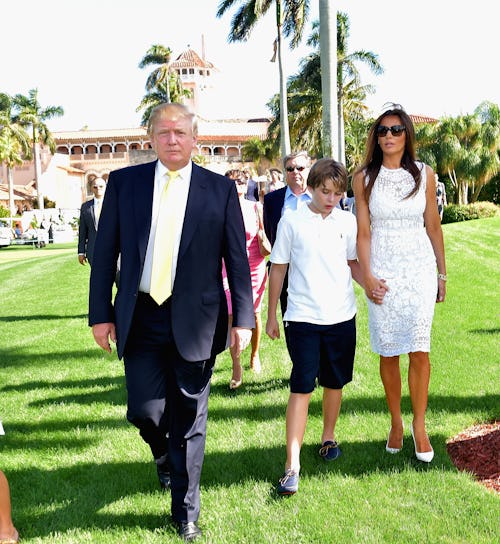 Donald Trump with his wife Melania and son Baron in front of the Mar-A-Lago mansion