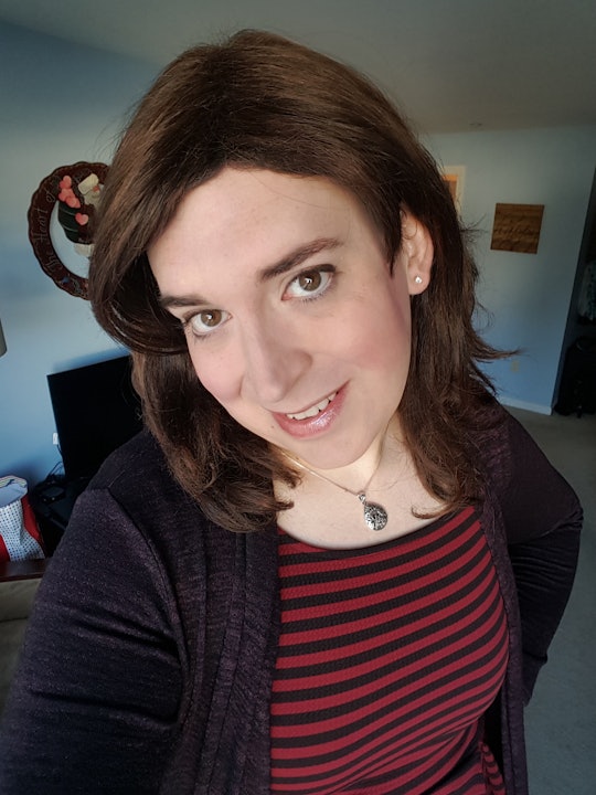 Katelyn Burns, a trans mom in a black-red shirt and black jacket in a selfie