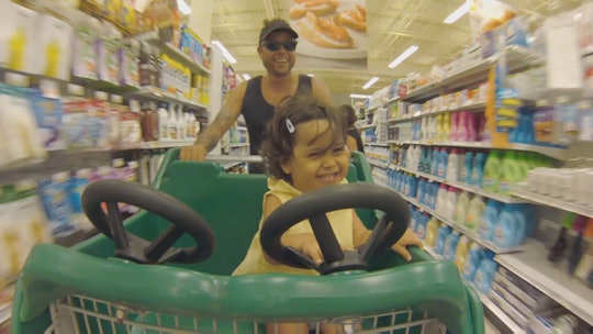 A dad with his daughter in the shopping cart in Dove's #RealDad video