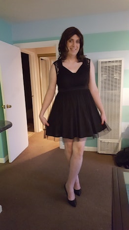 A transgender mom, Katelyn Burns, posing in a black cocktail dress